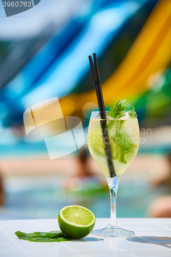 Image of Close up Cocktail margaritas with lime near the swimming pool