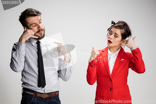 Image of The business man and woman communicating on a gray background