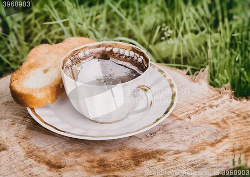 Image of Still life: a Cup of black coffee in the garden.