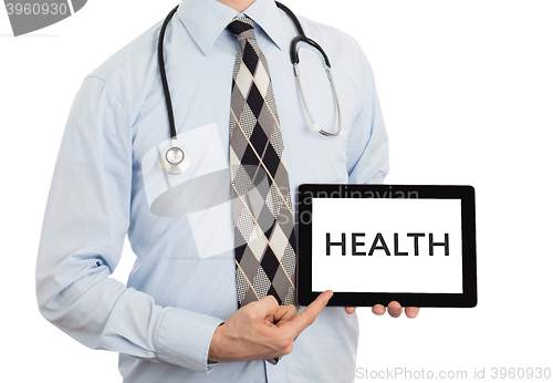 Image of Doctor holding tablet - Health