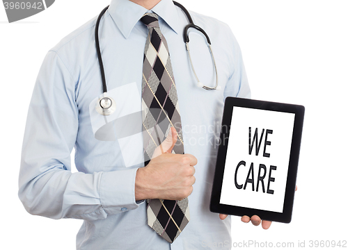 Image of Doctor holding tablet - We care