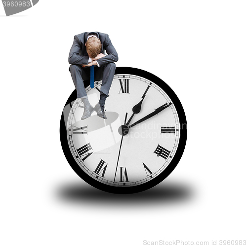 Image of Tired businessman on clock