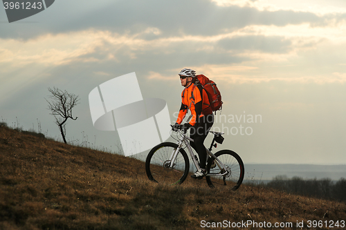 Image of Man cyclist with backpack riding the bicycle