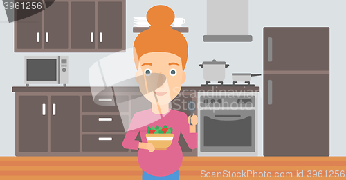 Image of Pregnant woman eating salad.