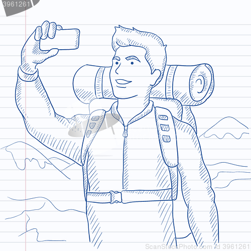 Image of Backpacker making selfie.