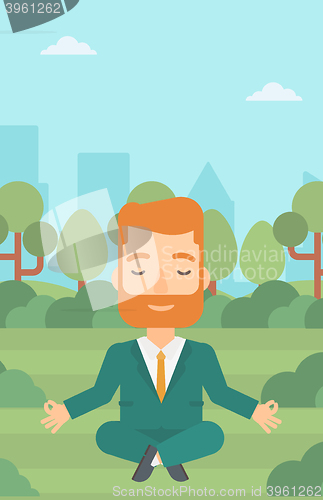 Image of Businessman meditating in lotus pose.