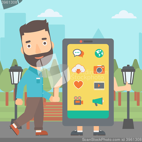 Image of Man walking with smartphone.