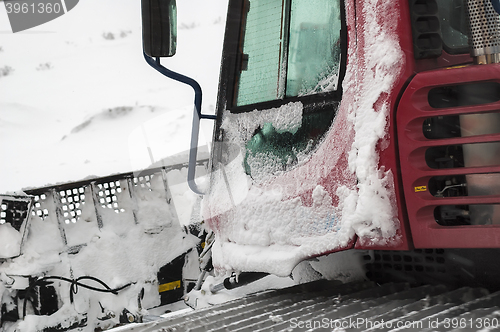 Image of Frozen snowplow in snow blizzard