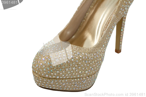 Image of Sparkly toe of a gold fashionable high-heeled shoe