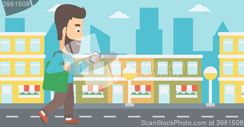 Image of Man walking with smartphone.