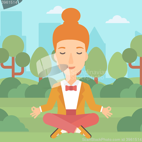 Image of Business woman meditating in lotus pose.