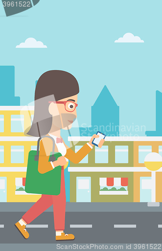 Image of Woman walking with smartphone.