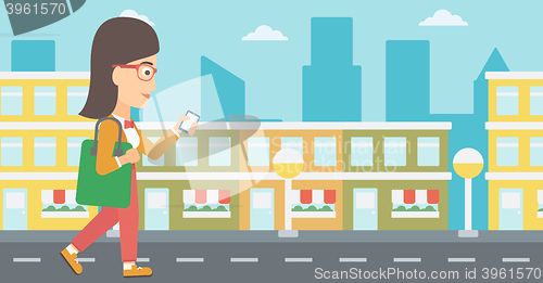 Image of Woman walking with smartphone.