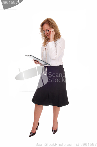 Image of Business woman looking at her clipboard. 