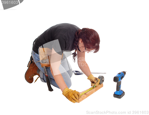 Image of Woman working with tools.