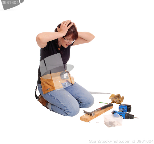 Image of Woman confused what she did with tools.