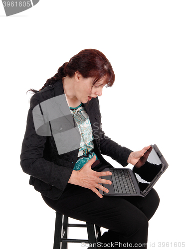 Image of Woman wondering what is on laptop.