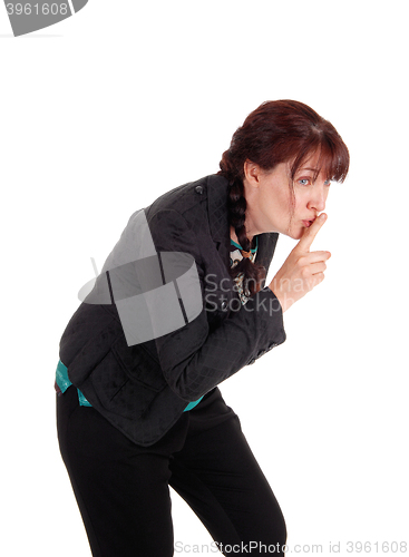 Image of Middle age woman with finger over mouth.