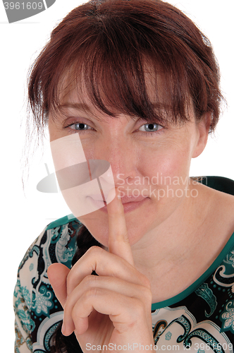 Image of Lovely woman holding finger over mouth.