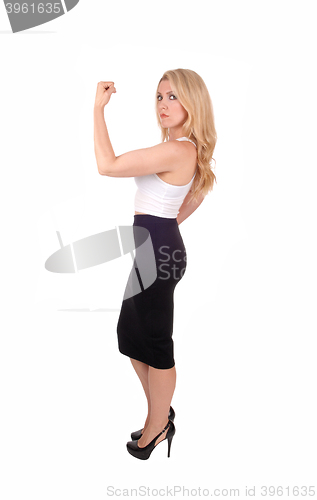 Image of Blond woman showing her muscles.