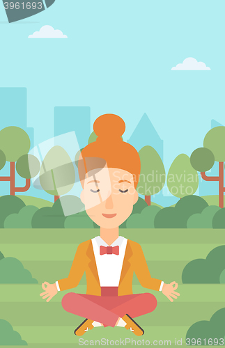 Image of Business woman meditating in lotus pose.