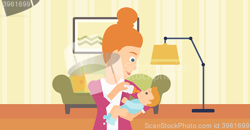 Image of Woman feeding baby.