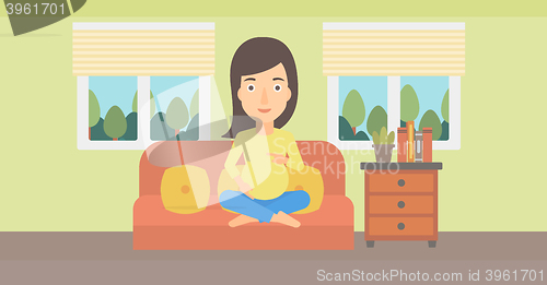 Image of Pregnant woman sitting on sofa.