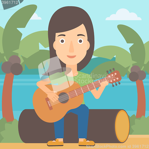 Image of Woman playing guitar.