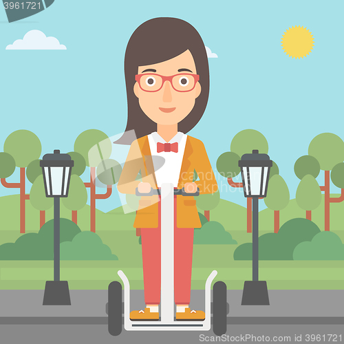 Image of Woman riding on electric scooter.