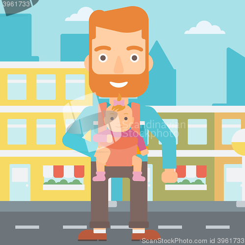 Image of Man holding baby in sling.