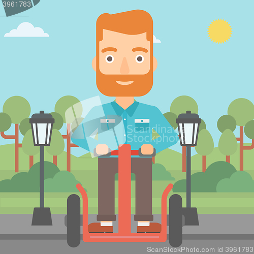 Image of Man riding on electric scooter.