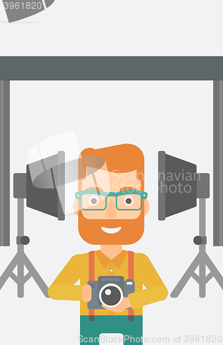 Image of Smiling photographer holding camera.