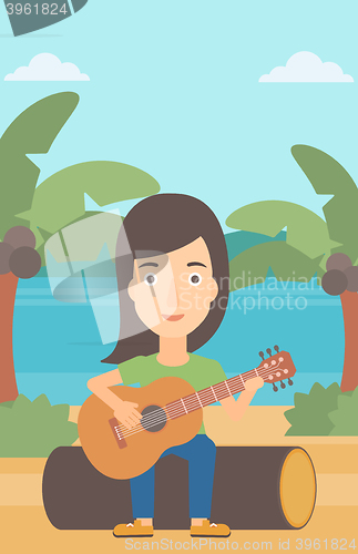 Image of Woman playing guitar.