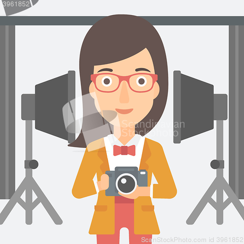 Image of Smiling photographer holding camera.