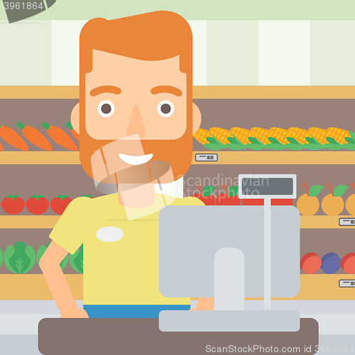 Image of Salesman standing  at checkout.