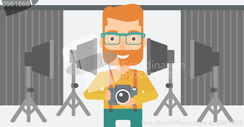 Image of Smiling photographer holding camera.