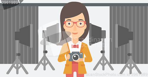 Image of Smiling photographer holding camera.