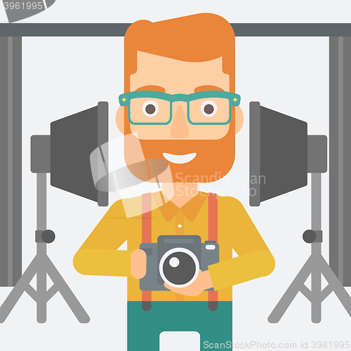 Image of Smiling photographer holding camera.