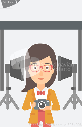 Image of Smiling photographer holding camera.