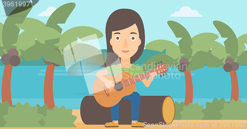 Image of Woman playing guitar.