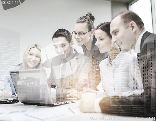 Image of business team with laptop having discussion