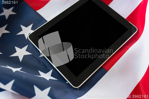 Image of close up of tablet pc computer on american flag