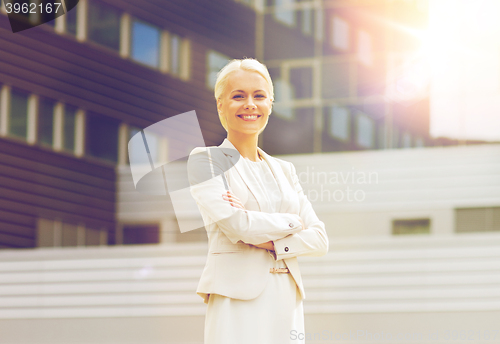 Image of young smiling businesswoman with crossed arms