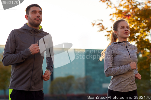 Image of couple running outdoors