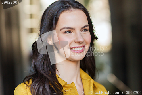 Image of smiling young woman in city