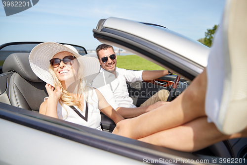 Image of happy man and woman driving in cabriolet car