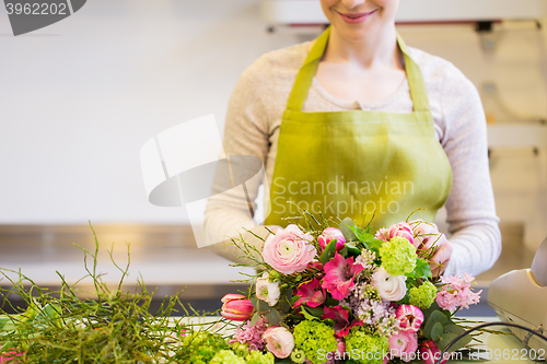 Image of close up of woman making bunch at flower shop