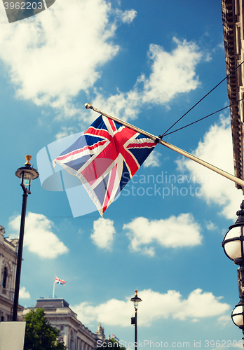 Image of union jack flag waving on london city street