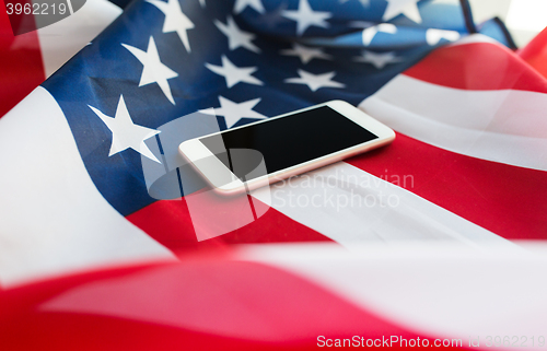 Image of close up of smartphone on american flag