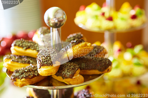 Image of Dessert table for party. akes and sweetness. Shallow dof